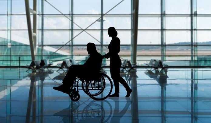 Airport - women pushing a person in wheelchair